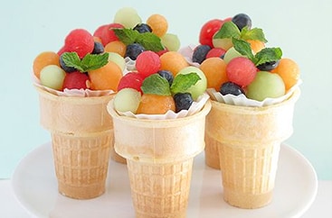 Fruit salad in ice cream cones Fruit salad in ice cream cones