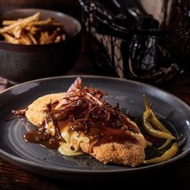 Chicken Schnitzel with Jalapeño Gravy, Cheese, Bacon, and Onions Chicken Schnitzel with Jalapeño Gravy, Cheese, Bacon, and Onions