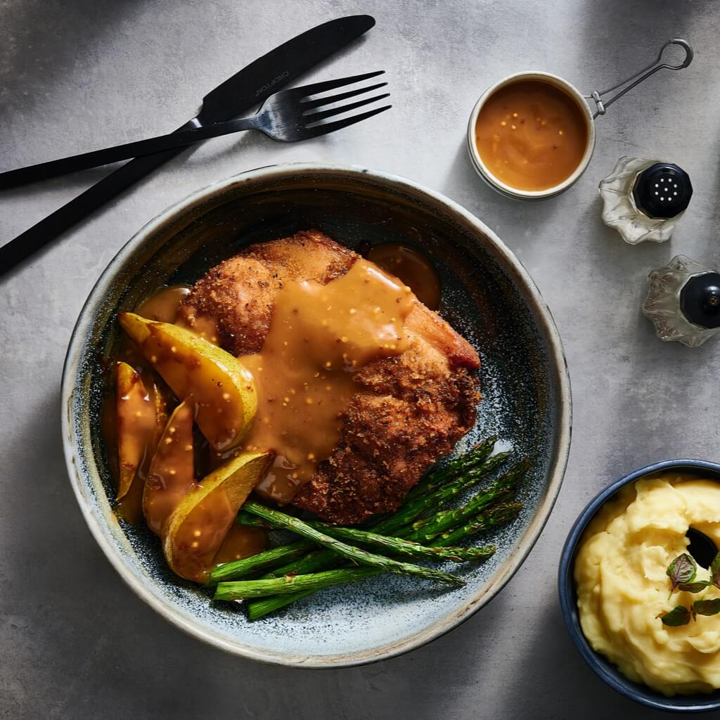 Pork schnitzel with garam masala crumb and curried gravy with pear Pork schnitzel with garam masala crumb and curried gravy with pear